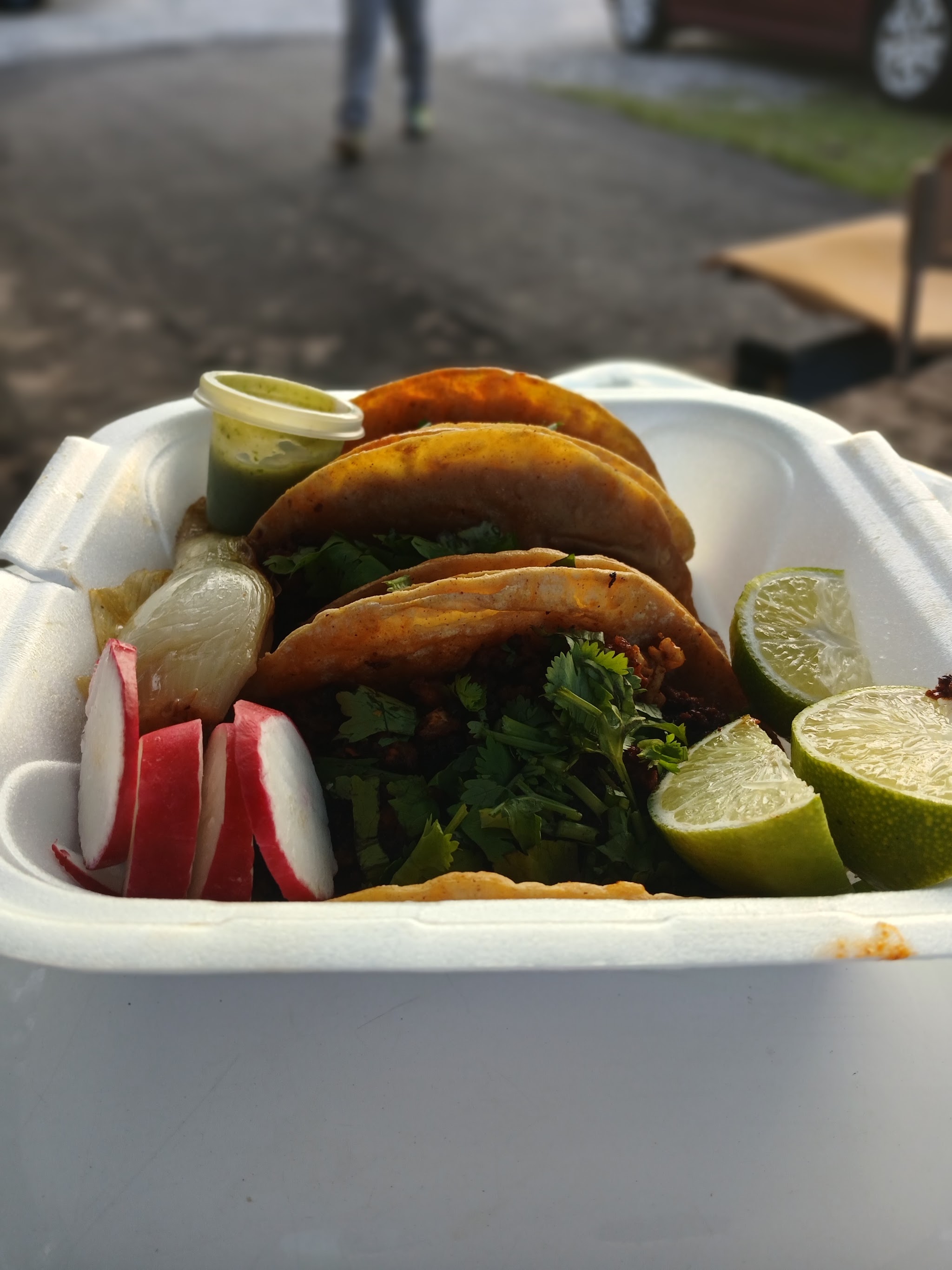 Tacos topped with radish and lime wedges