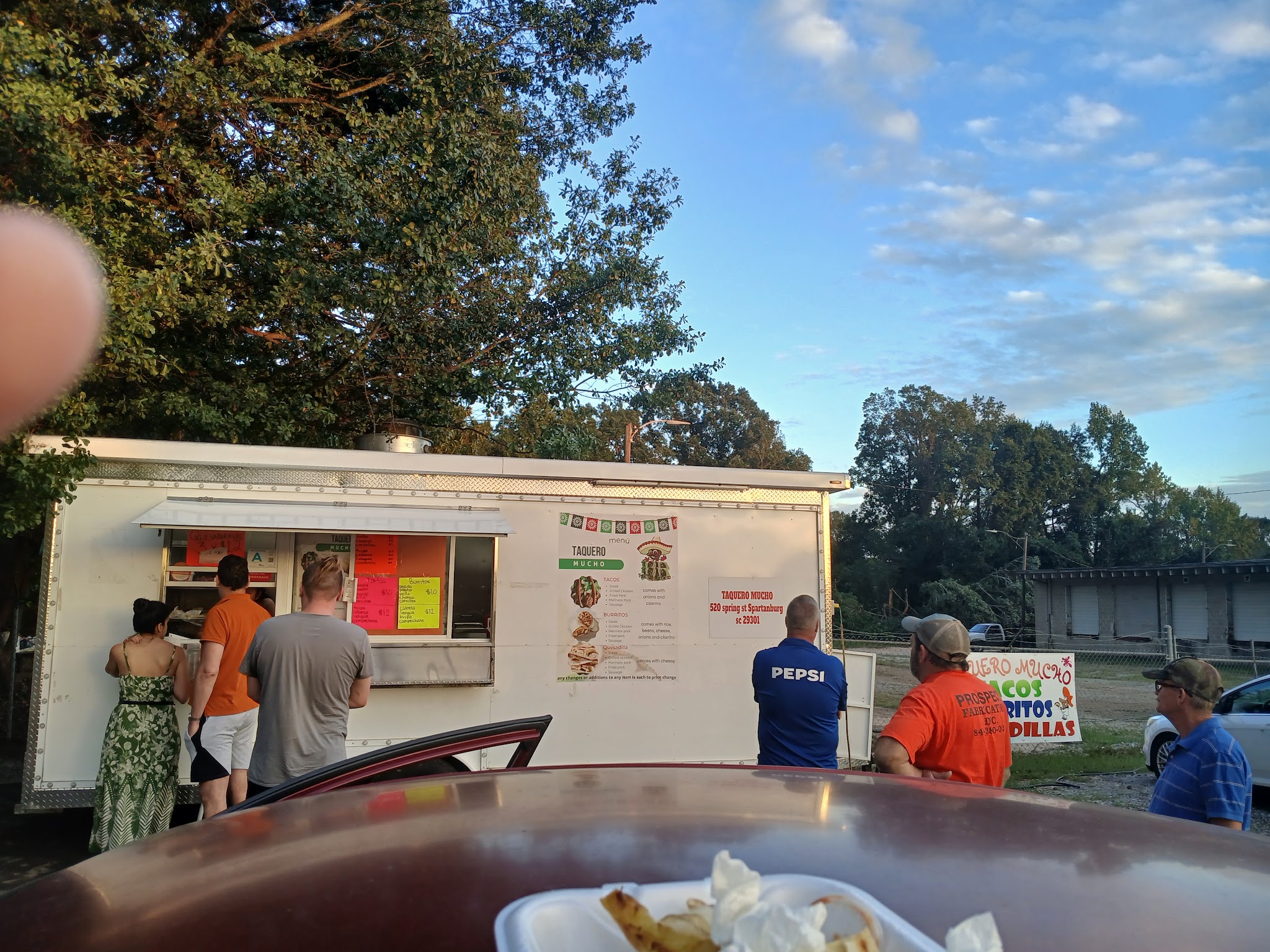 The Taquero Mucho food truck with customers lined up at the window